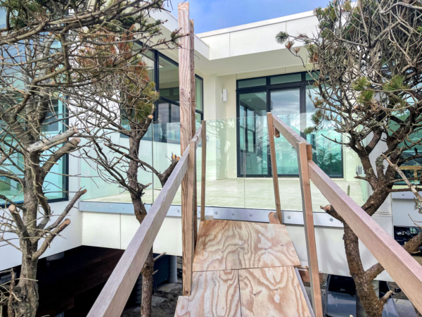 Glass railing being installed to the decks of this home in Cloverdale, OR