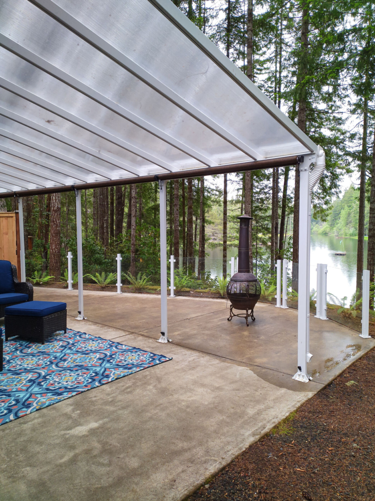 White frameless glass railing on patio overlooking a lake