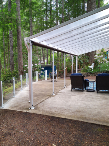 Glass railing lines this covered patio in Grapeview, WA