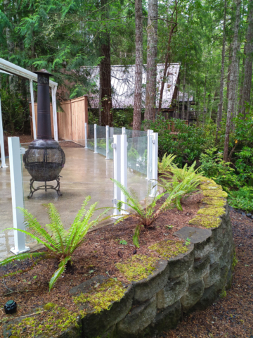 Frameless glass railing on a concrete patio in Grapeview, WA