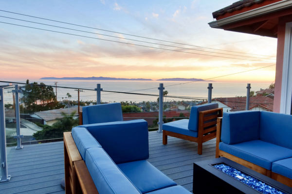 Frameless silver glass railing completes this cozy outdoor living space in San Pedro, CA