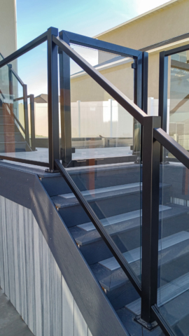 Close up of the custom glass railing gate on this deck in Tooele, UT.