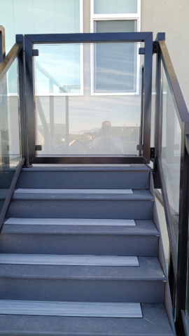 Glass railing gate makes these stairs more safe on a deck in Tooele, UT.